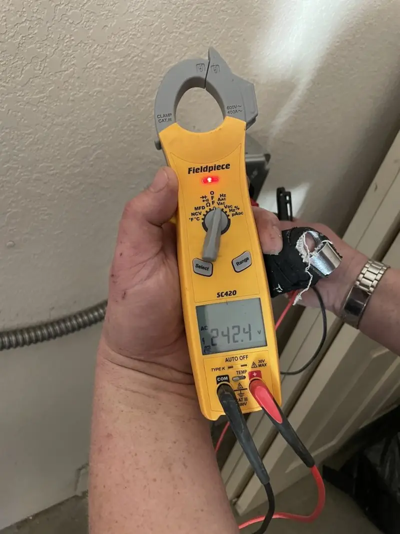 Voltage testing with clamp meter during Outlet Installation in Spokane Valley